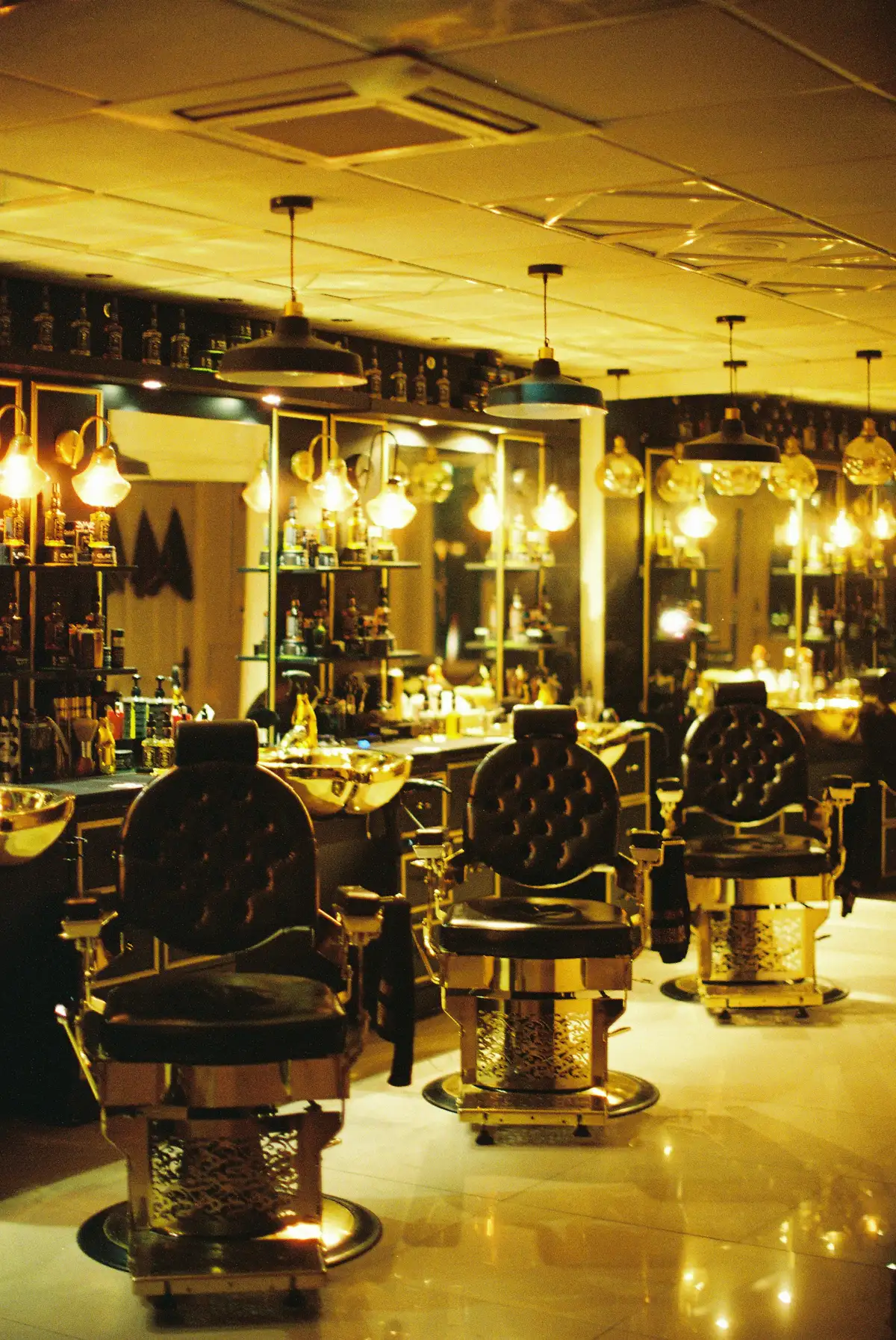 Barber lounge with leather chairs and warm lights
